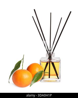 Citrus scented reed diffuser and fresh tangerines isolated on white Stock Photo