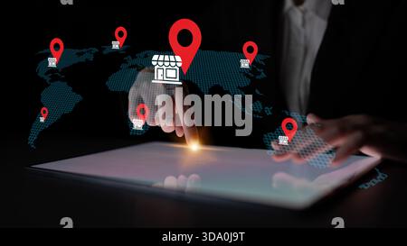 A person using a digital tablet interacts with a dynamic map displaying location markers, highlighting the intersection of technology and global Stock Photo
