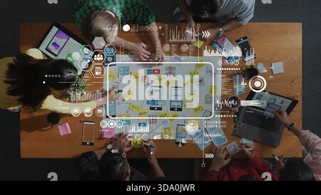 A diverse team collaborates in a modern workspace, brainstorming innovative strategies with sticky notes and devices, showcasing creativity and Stock Photo