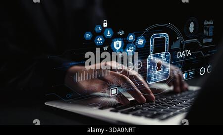This image showcases a high-tech cybersecurity concept, highlighting hands working on a laptop with a digital lock icon and data analysis graphics on Stock Photo