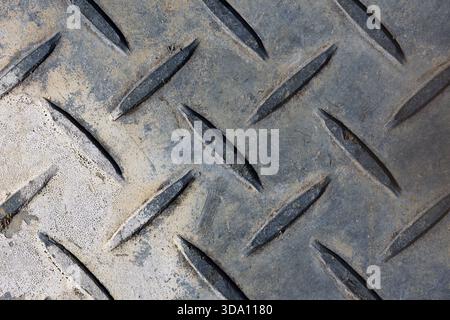 Weathered metal diamond plate close-up abstract background texture Stock Photo