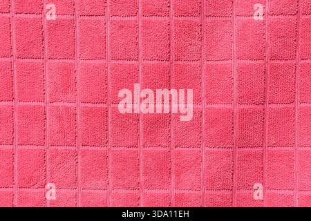 Pink fabric with a grid pattern close-up abstract textured background Stock Photo