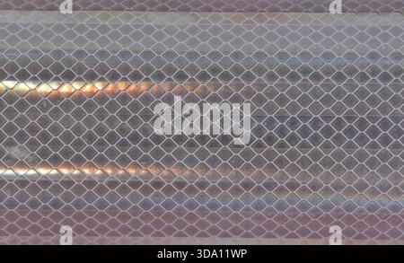 Diamond-patterned mesh close-up abstract textured background Stock Photo