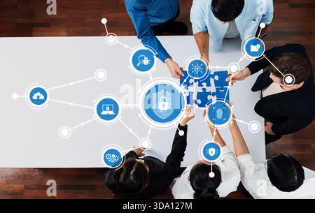 A diverse team collaborates on a cybersecurity strategy, using puzzle pieces to symbolize connection and protection in a digital workspace, fostering Stock Photo