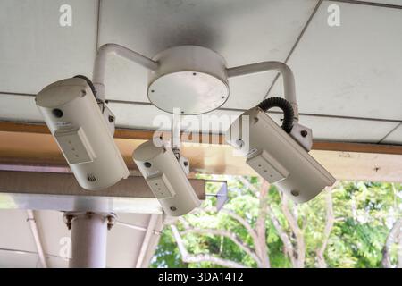 Security cameras are mounted on the ceiling, overseeing the bustling area of Orchard Road in Singapore, ensuring safety and surveillance in a vibrant Stock Photo
