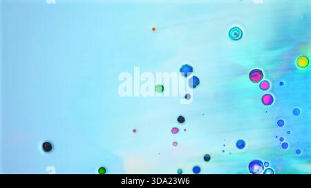 Vibrant colorful circular forms floating in a gentle light blue fluid Stock Photo