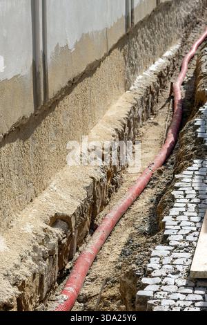 Cable laying in a shaft at the foundation outside Stock Photo