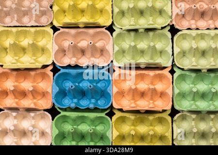 Open empty egg box cartons in different colours, viewed from above in a grid pattern Stock Photo