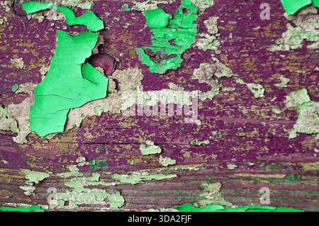 Texture grunge background - green and purple peeling paint on the wooden texture surface, textured peeling paint background Stock Photo