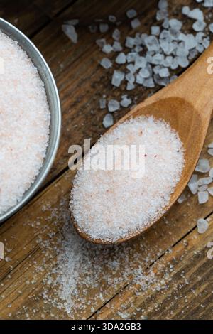 Pink Himalayan Salt in Wooden Spoon on Rustic Wooden Background Stock Photo