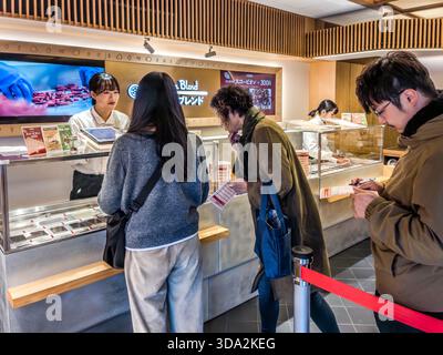 Customers queuing at the counter in the Yawataya Isogoro flagship store on Daimon-cho in Nagano City, Nagano Prefecture, Japan Stock Photo