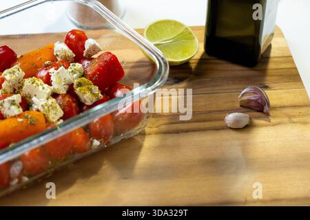 Cherry Tomatoes, Mini Peppers and Feta in Glass Dish – Mediterranean Meal Prep with Fresh Vegetables and Herbs Stock Photo