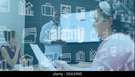 Presenting Black man wearing blue shirt leading meeting in room, with projector laptop and overlays Stock Photo