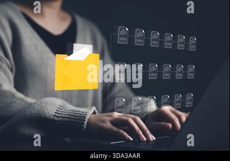 DMS, Document Management System Technology Concept. Businesswoman use laptop with document management system, yellow folder for multiple documents, or Stock Photo