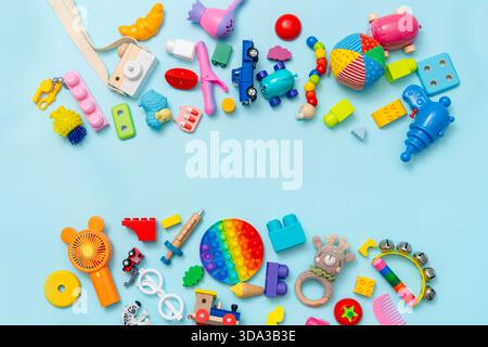 Lots of different children's toys on a blue background with space for text, top view, flat lay Stock Photo