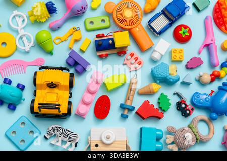 Lots of different children's toys on a blue background with space for text, top view, flat lay Stock Photo