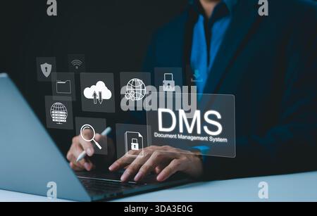 Digital Document Management System Concept. Businessman using laptop, with icons represent document management system (DMS). The concept highlights cl Stock Photo