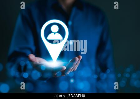 Targeted Marketing and Customer Strategy Concept. A person holds icon of a location marker with user symbol, target marketing, and customer centric. P Stock Photo