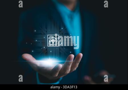 Smart Home Technology, IoT Integration Concept. Businessman presents smart home technology icon in his hand, representing IoT integration. Future of c Stock Photo