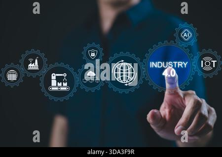 Smart industry 4.0 and automation concept. Man interacts with digital interface Industry 4.0 icons, symbolizing smart manufacturing, AI, IoT, automati Stock Photo