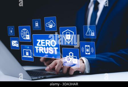 Zero Trust Security and Cyber Protection Concept. Businessman use laptop with interface "Zero Trust" security icons, advanced cybersecurity measures, Stock Photo