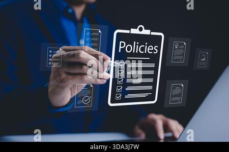 Policy documentation and compliance concept. A person reviews digital document labeled "Policies" with icons, checklists, certifications and financial Stock Photo