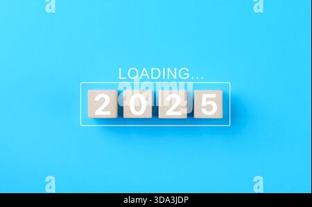 Loading 2025 New Year progress concept. Wooden blocks "2025" with the word "Loading" transition, planning, and preparation for 2025. business strategy Stock Photo