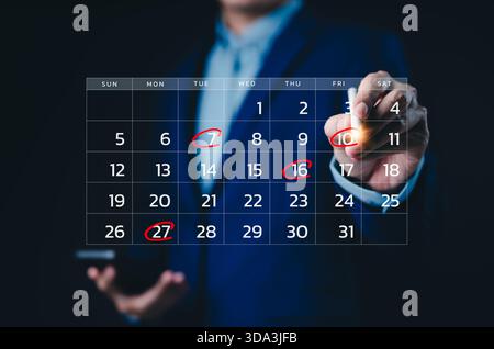 Calendar agenda appointment meeting schedule concept. Businessman using pen to writing circle red mark on virtual calendar. Planning Organizer, Time Stock Photo