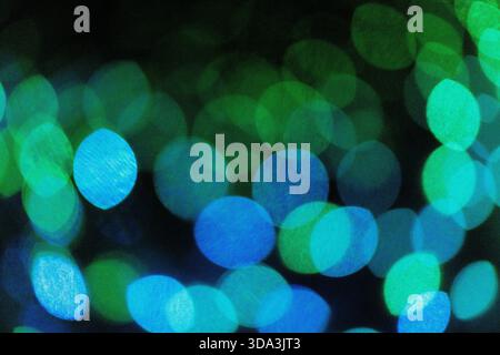 Abstract image of colourful bokeh lights with soft-focus glowing circles, creating a vibrant and atmospheric background. Stock Photo