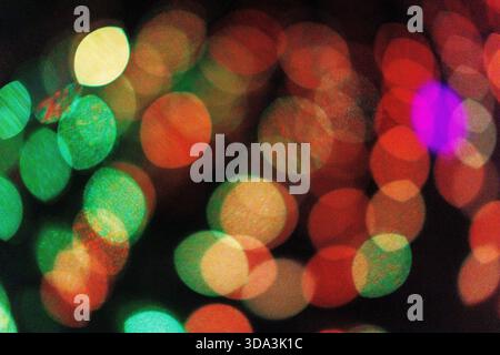 Abstract bokeh lights in vibrant colours, creating a soft-focus, glowing background. Stock Photo