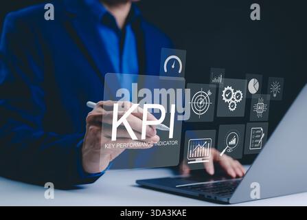 KPI, Analyzing Key Performance Indicators. Businessman use laptop to analyze key performance indicators (KPIs) with various graphs, work tools, Stock Photo