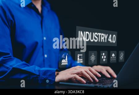 Smart industry 4.0 and factory automation concept. A person using a laptop with interface "Industry 4.0" symbolizes smart manufacturing, automation, Stock Photo