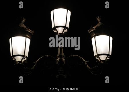 Dublin, Ireland - 03rd December 2025 - O'Connell Bridge street lamps illuminated on a dark early morning in Dublin city depicting street life in the Irish Capital Stock Photo