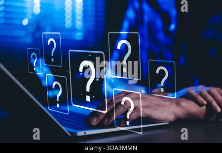 Question Mark and Problem Solving Concept. A person using a laptop with floating question marks, symbolizing brainstorming, problem-solving, Stock Photo