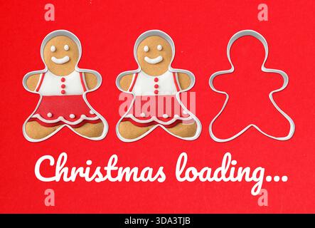 Christmas loading, expectation of holiday. Gingerbread cookies with icing on red background Stock Photo