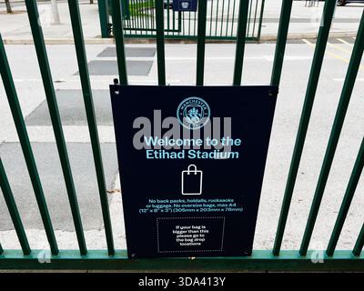 Manchester, UK - November 16, 2025: Blue sign at a gate in Manchester City Stadium provides welcome and luggage guidance. Stock Photo