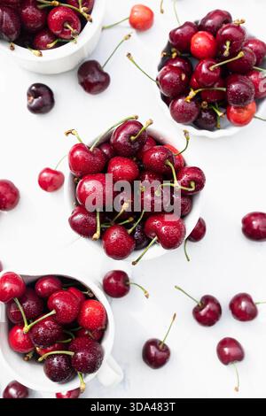 Close-up of fresh red cherries with water droplets on a white background Stock Photo