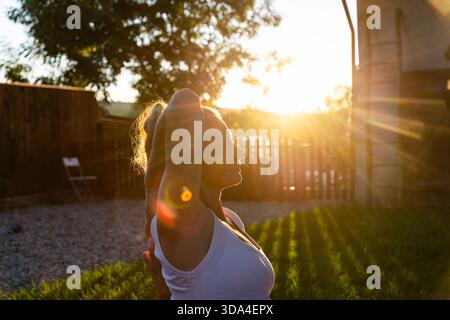 woman doing yoga at sunset outdoors Stock Photo