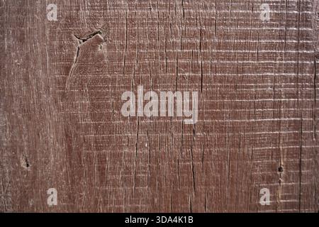 A close-up view of a worn and weathered wooden surface with visible scratches and marks Stock Photo
