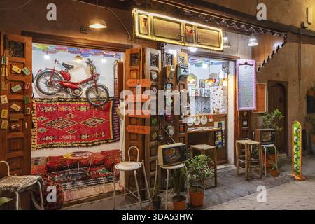 Colourful cafe with decoration and lights, a wheel hanging on the wall Stock Photo