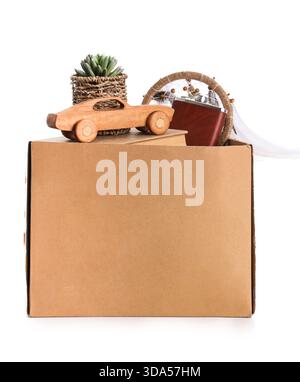 Box of unwanted stuff for garage sale on white background Stock Photo