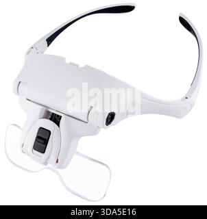 Binocular magnifying glasses with lighting for precise soldering of small electronic components. On a white background in insulation. Stock Photo