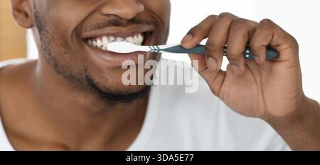 Daily Tooth Brushing Routine for Dental Health in a Bright Bathroom Setting Stock Photo