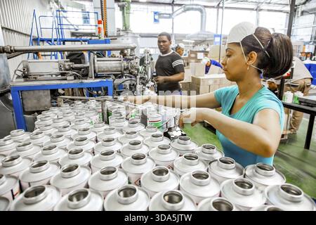Johannesburg, South Africa - October 19, 2012: Diverse people working on an assembly line in a glue factory Stock Photo