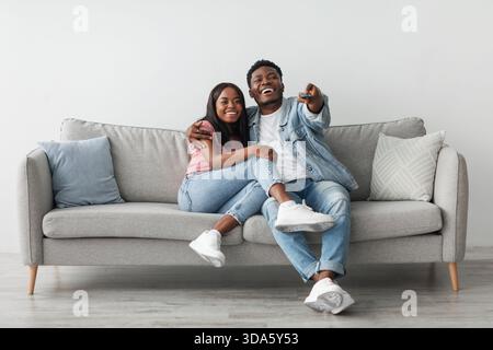 African American couple spending weekend together watching tv Stock Photo