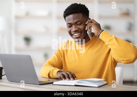 Happy unemployed black guy looking for job, talking to HR Stock Photo