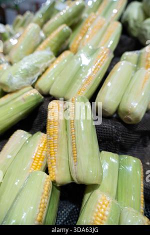 Fresh green vegetables like peas, beans, and cucumbers in a market for a healthy vegetarian diet Stock Photo