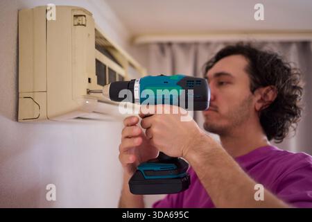 Technician Expertly Installing a New Air Conditioning Unit in a Contemporary Modern Home Stock Photo