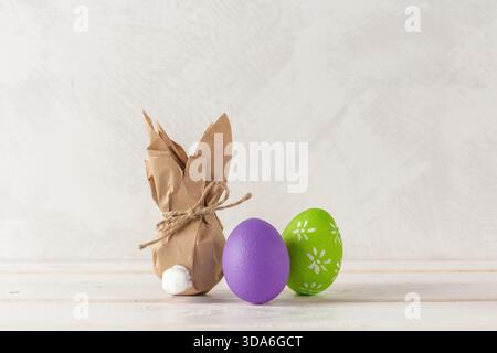 Colorful Easter decorations featuring a bunny and painted eggs on a light background Stock Photo