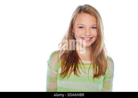 Happy, fashion and portrait of girl in studio with confidence, trendy clothes and pride. Smile, space and child model with stylish outfit for Stock Photo